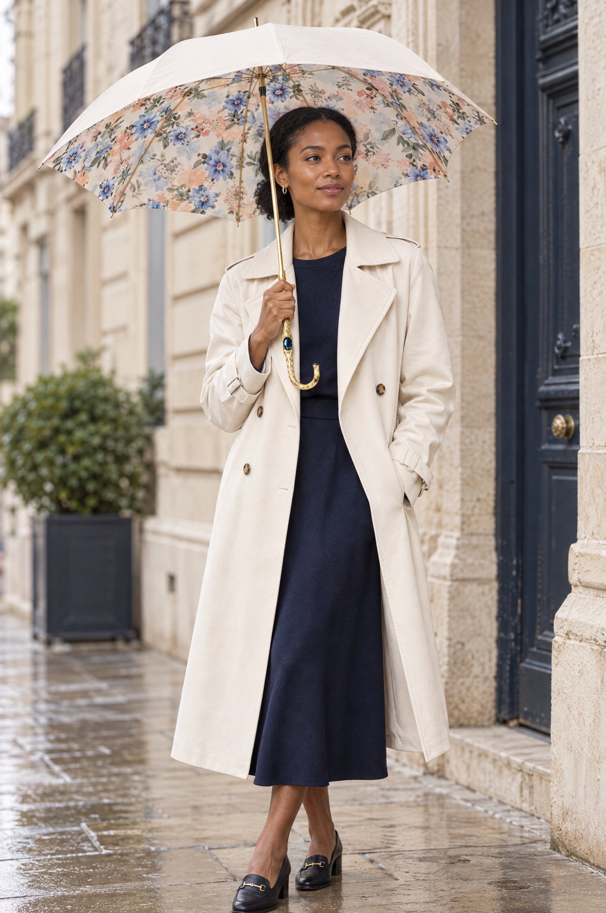 A woman carrying a Pasotti umbrella in an architectural city setting.